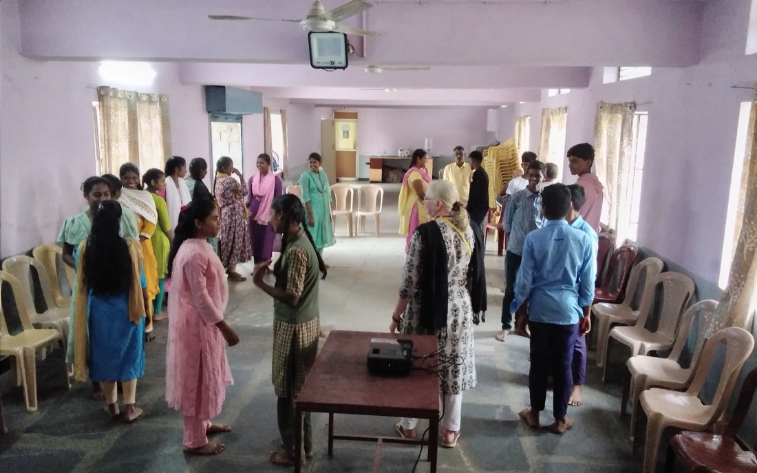 Adolescents standing in a circle during an interactive group session