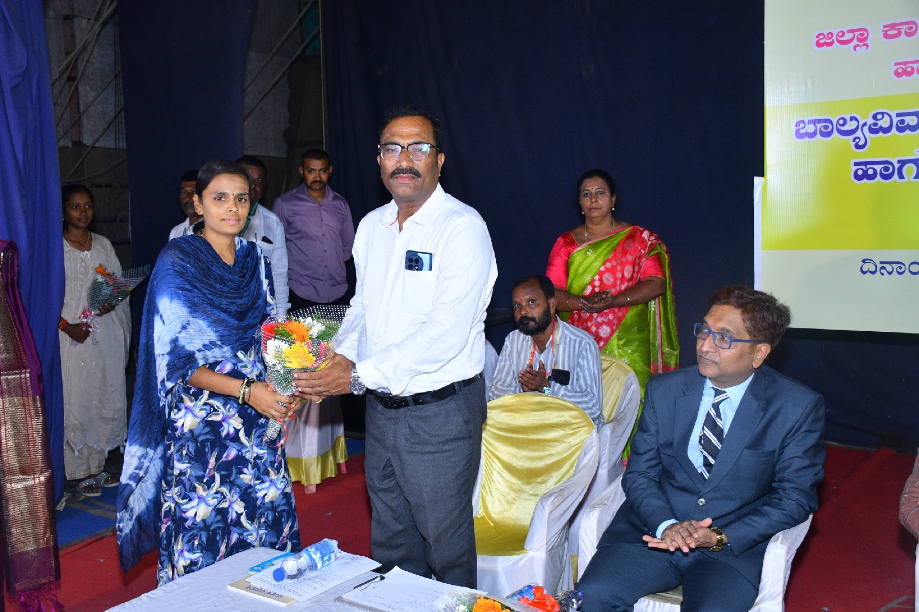 A participant felicitated with a bouquet at an evening programme