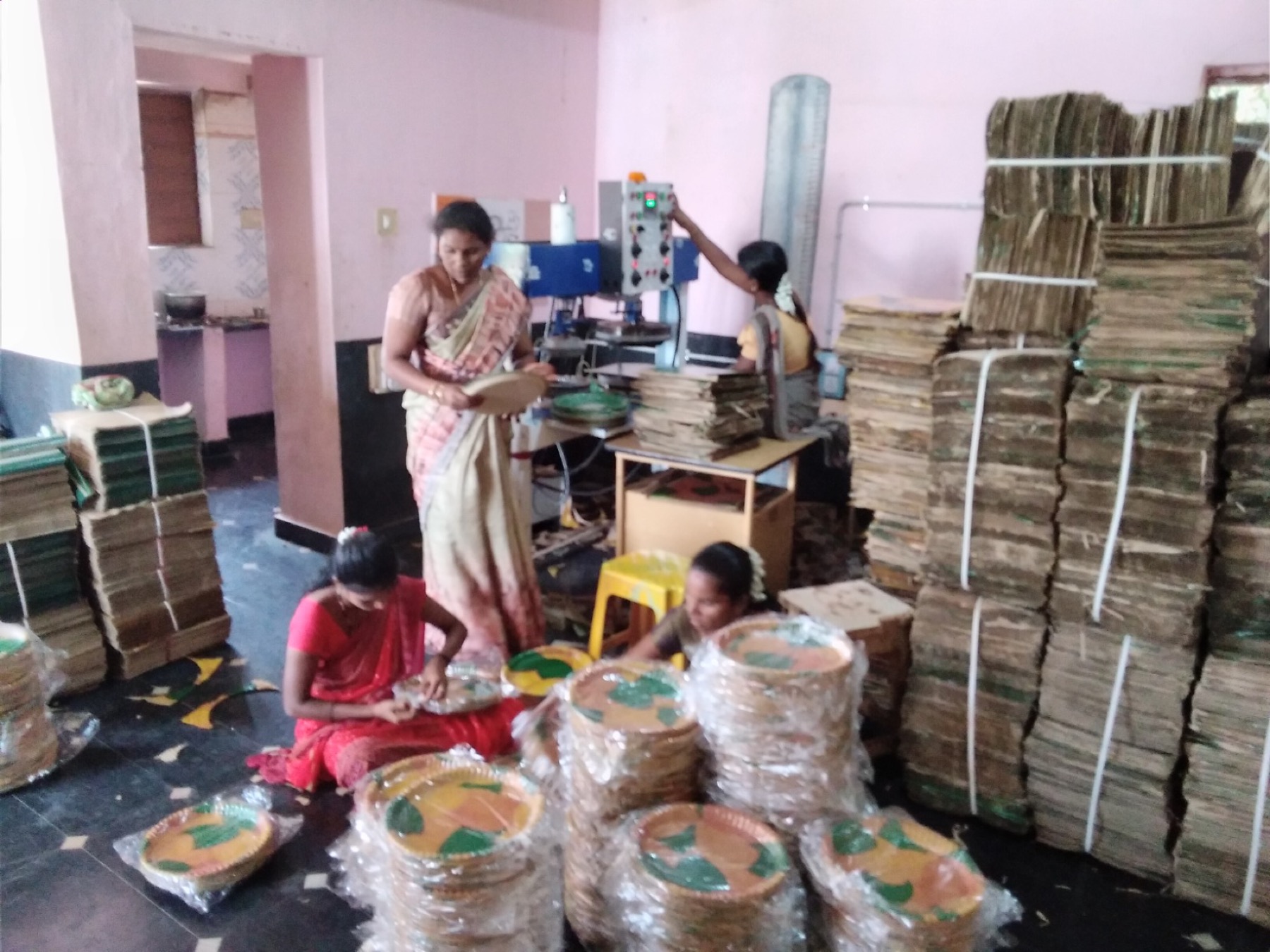 Women producing eco-friendly leaf plates at a livelihood unit