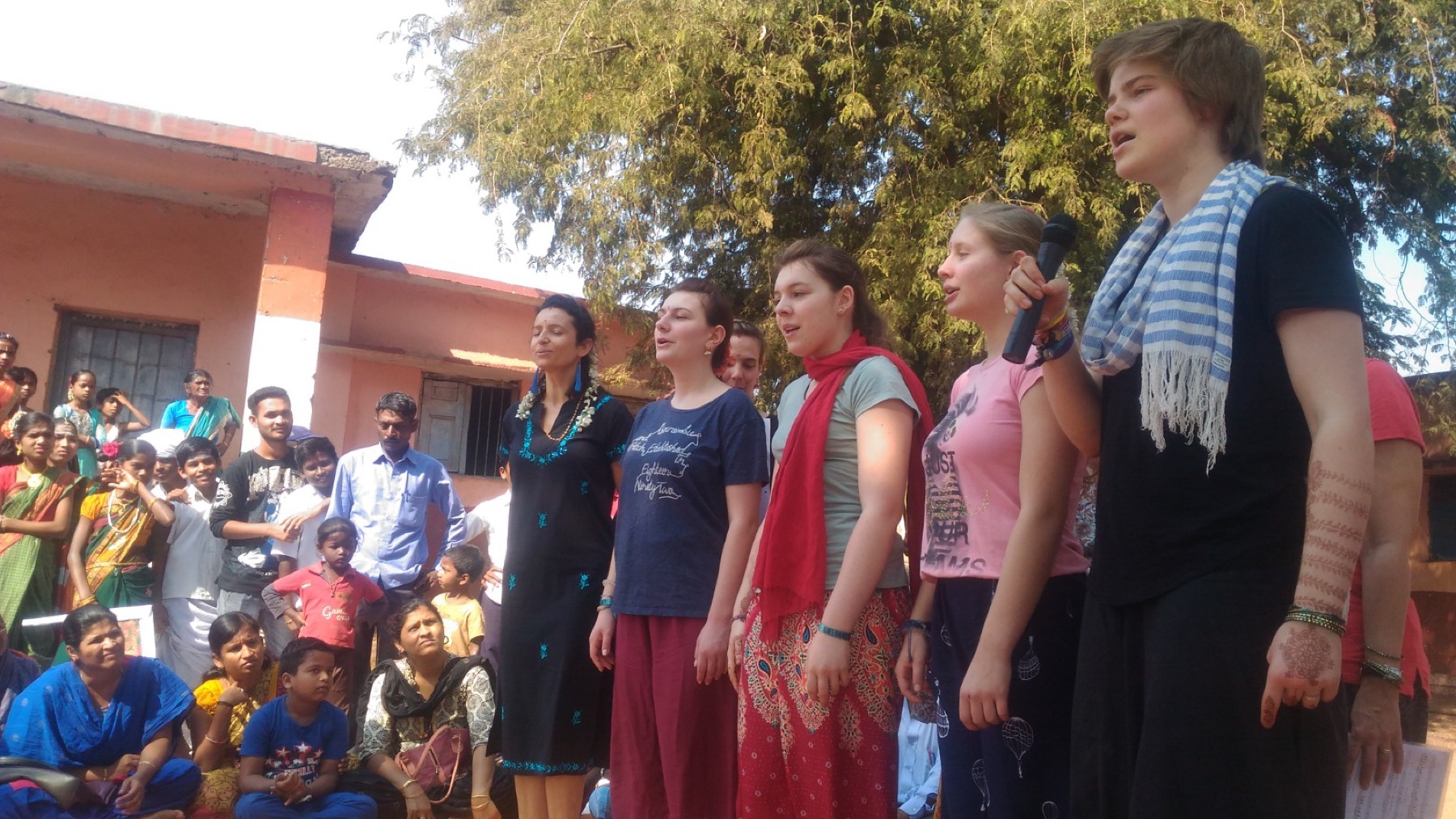 International volunteers singing with the local community